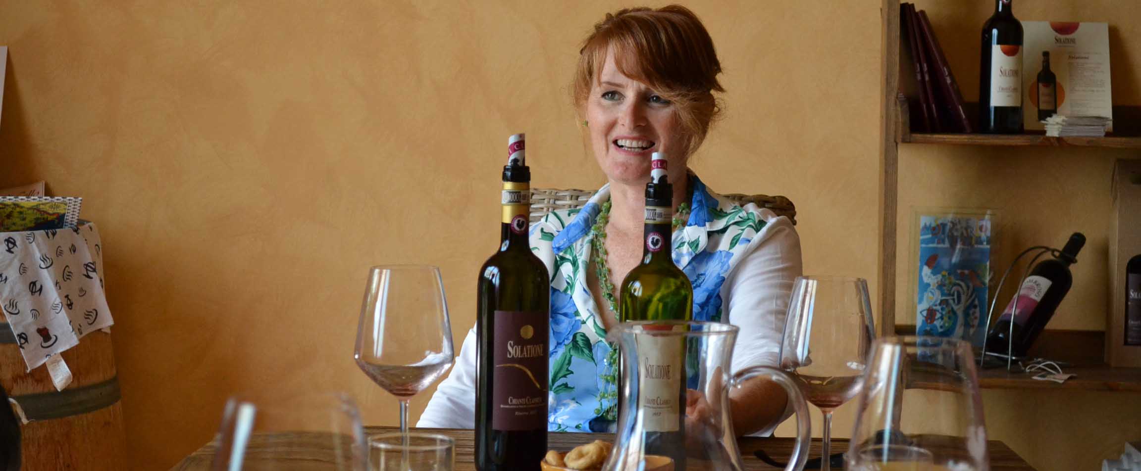 Three people walking through rows of vines during a wine tour Three people walking through rows of vines during a wine tour